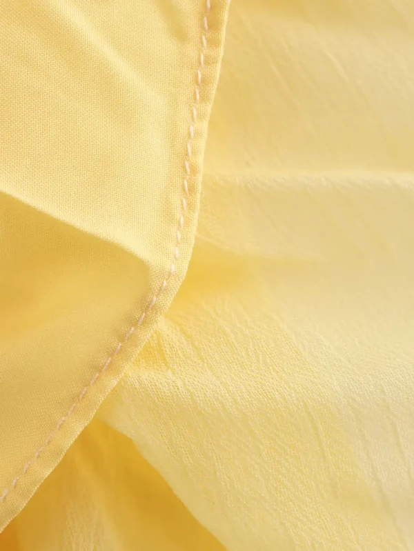 تنورة YENKYE للسيدات مجعدة على شكل حرف a ميدي باللون الأصفر والزبدة بخصر مطاطي تنانير أنيقة لعطلات الربيع والصيف جديدة 2025 faldas mujer